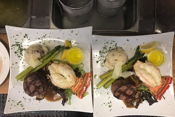 two steak dinners on square plates side by side